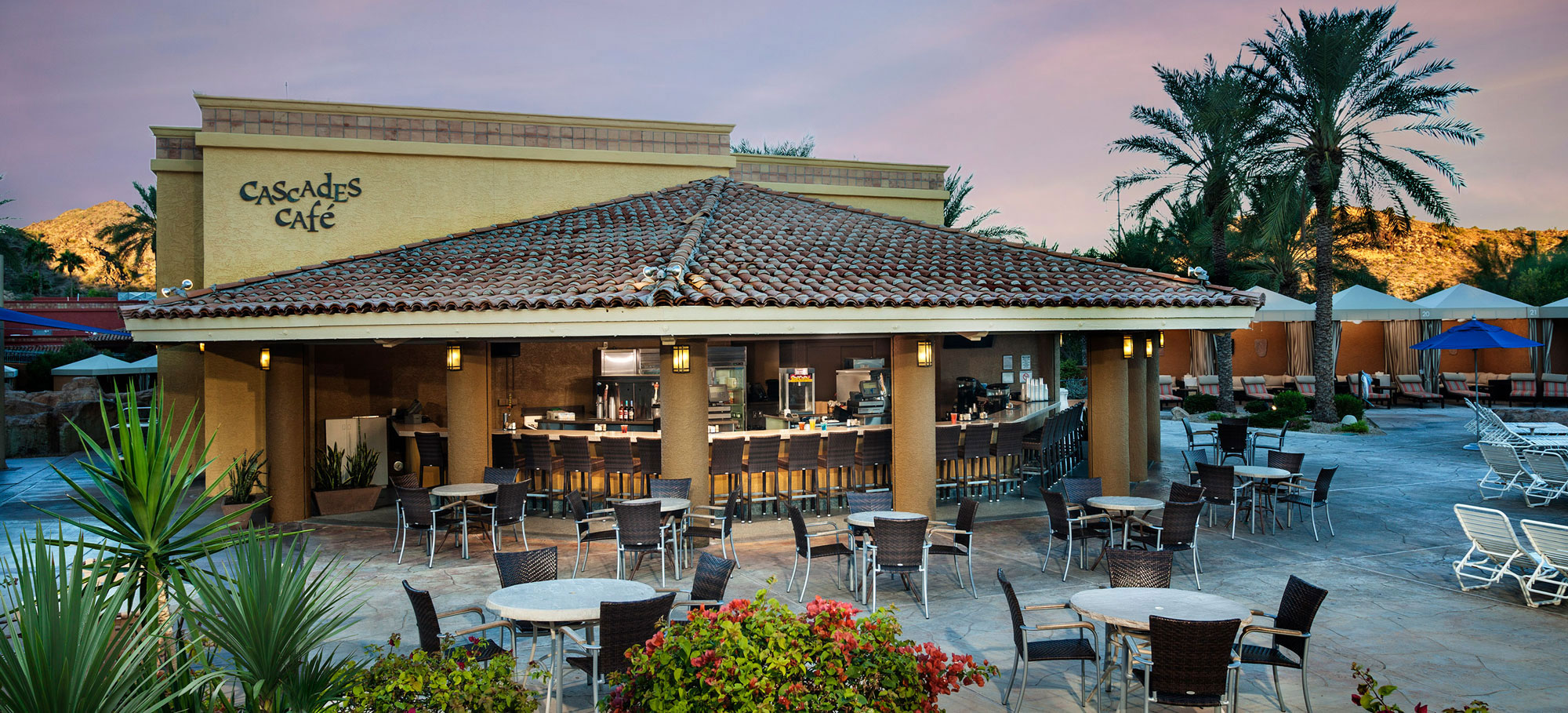 Cascades Cafe outdoor poolside bar with mountains and palm tree views