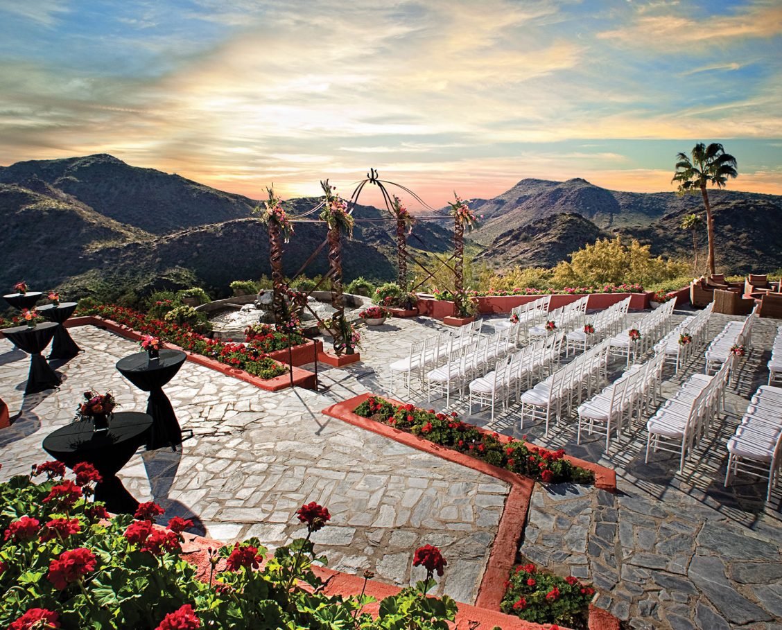 Outdoor wedding ceremony on the patio at Different Pointe of View restaurant with gorgeous mountain views