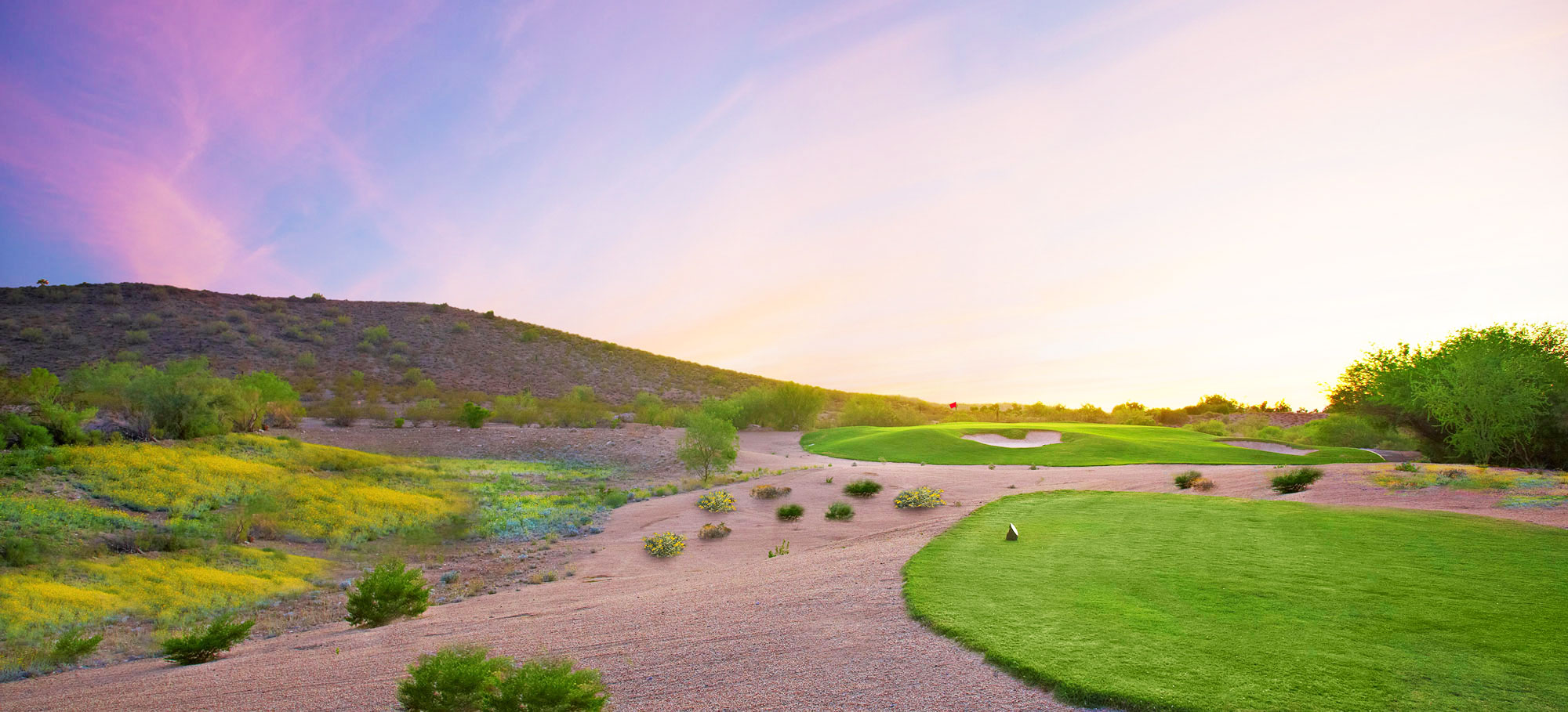 Green golf course at sunrise in the spring