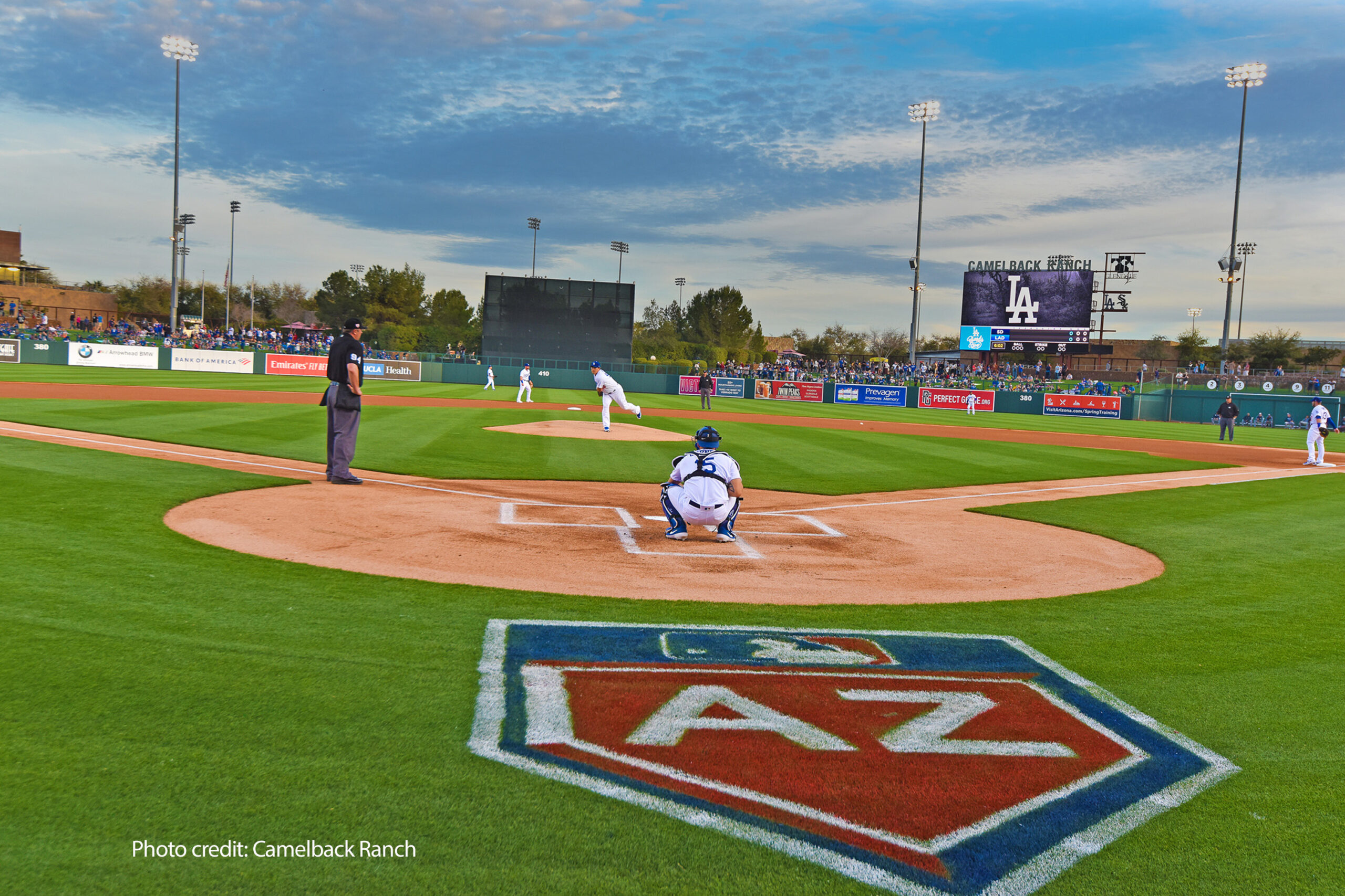 LA Dodgers Spring Training game at Camelback Ranch_VisitPhx_PhotoCred Arizona's Camelback Ranch spring training baseball field with players warming up before the game and fans sitting in the lawn watching